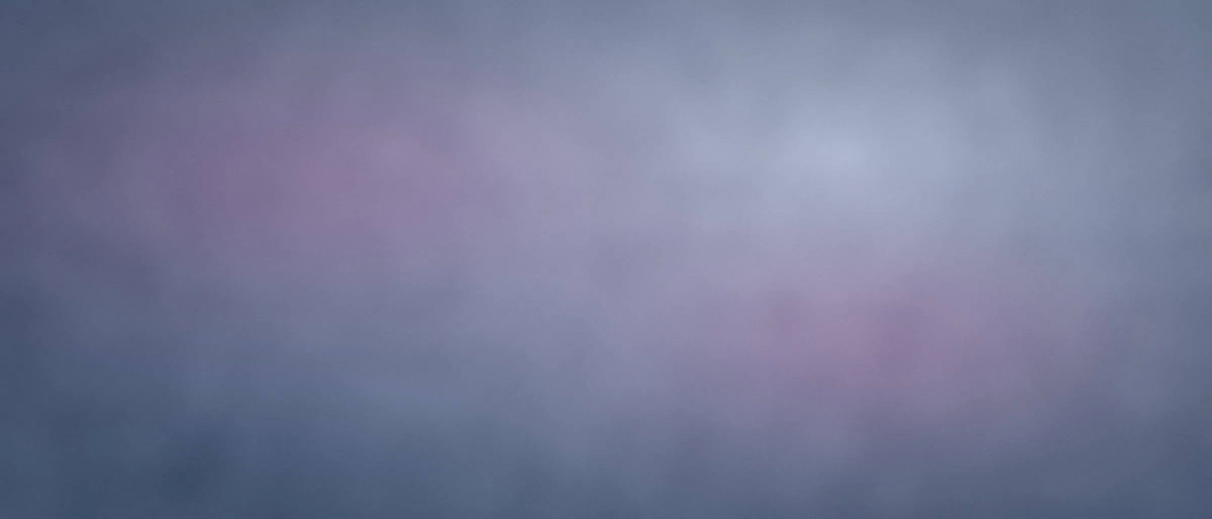 Wide sun-faded denim ground with pale bleach blooms.